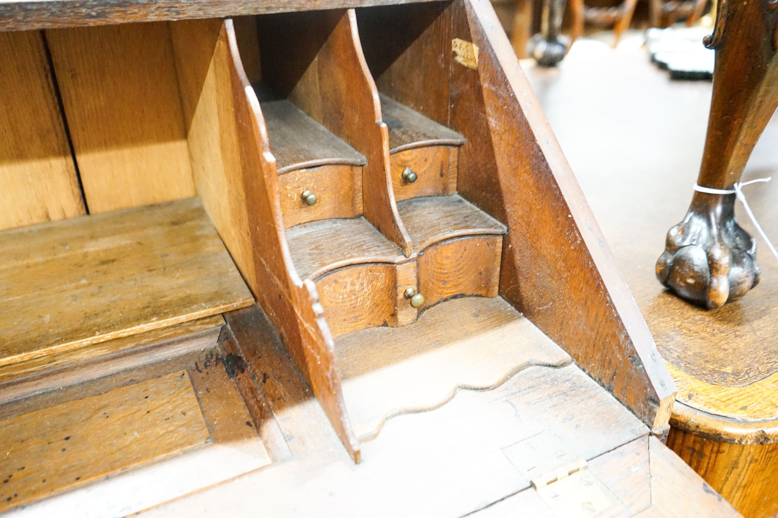 An 18th century later carved oak bureau, width 91cm, depth 53cm, height 101cm